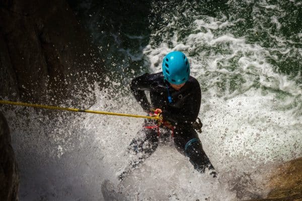 Camping Le Colporteur Ciela Village A rafter in a river with water splashes everywhere in Corsica, France